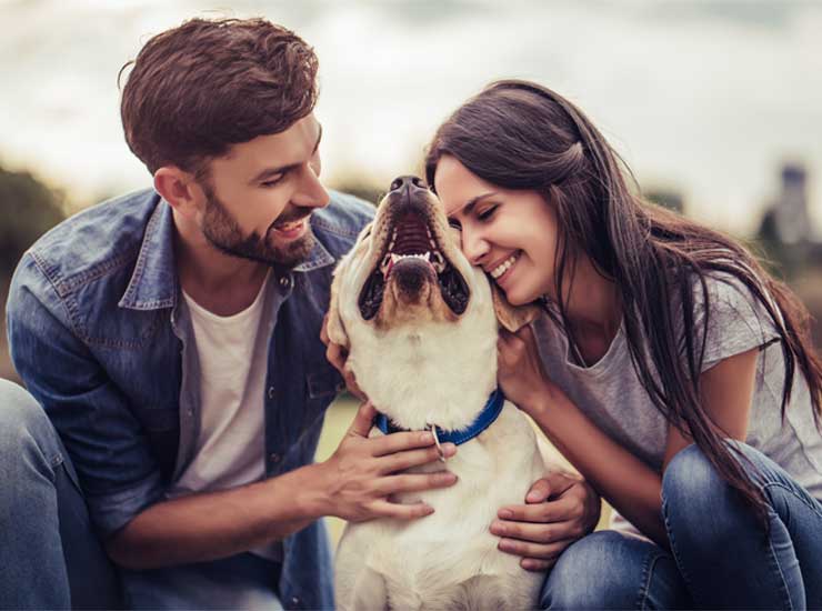 couple hugging their dog