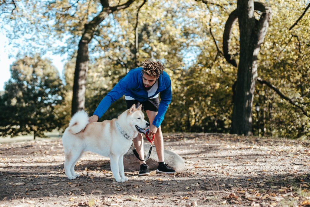 the dog is standing next to the boy